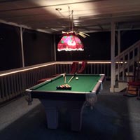 Upstairs screened in porch with pool table